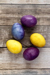 Easter colorful eggs on the table. Colored eggs. Easter still life. Wooden background. Place for your text. View from above. High quality photo