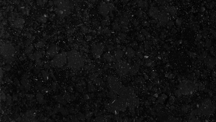 macro view of black grain granite stone texture with crystal pigments use as a background. dark...