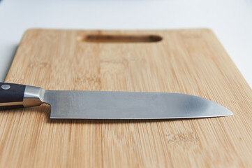 Kitchen knife on a wooden cutting board
