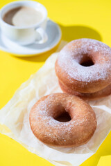 Homemade donuts and coffee on bright background. Food concept.