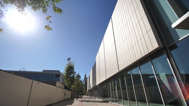 Walking by Pauley Pavilion Building, Los Angeles, University of California Sport Venue and Campus Landmark