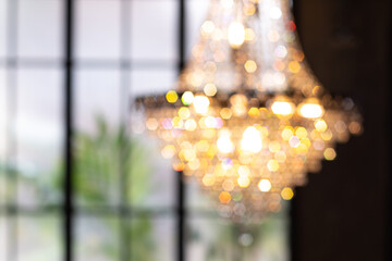 Abstract  blur chandelier with bokeh. Hanging Chandelier Lights Blurred Defocused Bokeh Background with blurred window on background