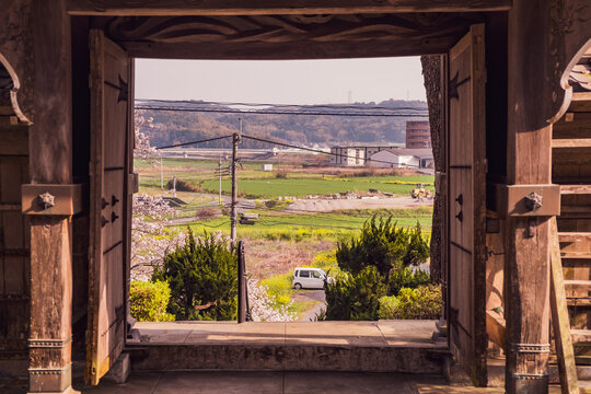 old wooden gate to leave the temple  with scenic background near Kitsuki, Japan
