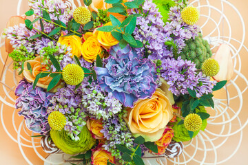 Beautiful spring bouquet, lilac, rose and blue carnation, top view