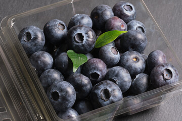 Fresh blueberries close-up in a plastic container. Products for a healthy diet. A source of vitamins.