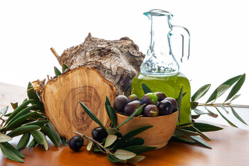 olive oil with olives on wooden table