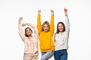 Young three young women dancing over white background