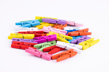 colored small clothes pegs on a white background