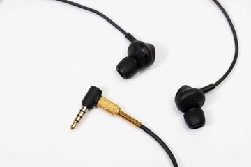 Top view in ear headphone isolate on white background , Black gold headphones.