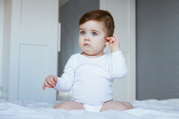 Little boy with ear pain moaning holding hand on ear at home, child headache pain, health care...