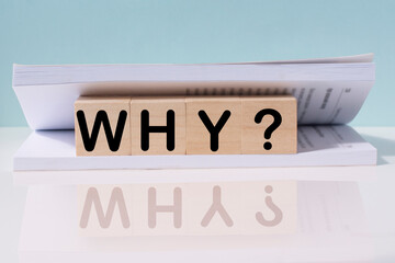 The question why on a wooden cubes . FAQ frequency asked questions, Answer and Brainstorming...
