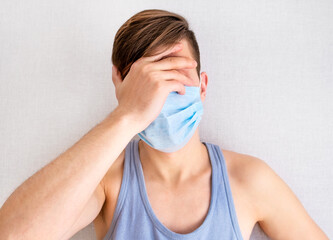 Sad Young Man in a Flu Mask