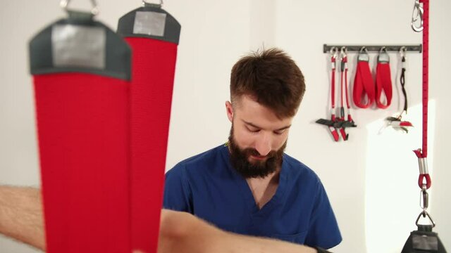 Orthopedic doctor makes a diagnosis of the muscle tone on legs. Manual therapy