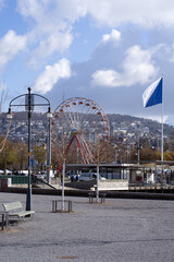 Obraz premium Square Burkliplatz at city of Zurich with flag of Zurich and ferris wheel in the background. Photo taken April 6th, 2021, Zurich, Switzerland.