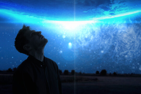 man watching the night sky, looking up, stars of milky way galaxy. elements of this image furnished by nasa