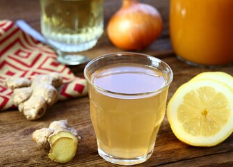 Hot tea against cough and flu made from onion, ginger, lemon and honey. Homemade tea from raw cut onion, lemon and ginger.