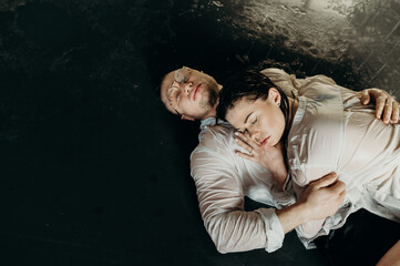 The guy hugs the girl. Heterosexual couple lifestyle moments at home. Conceptual photo about...