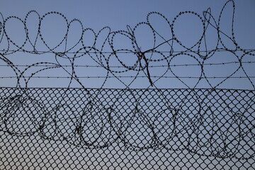 Airport security fence with blue sky on background