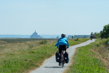 Cycling towards Mont-Saint-Michel along the Brittany coast on Eurovelo, France.