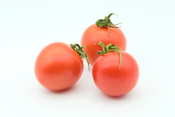 Three tomatoes on a white background