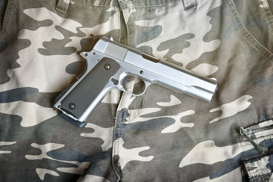 handgun on camouflage pant
