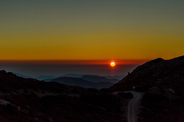 Beautiful Sunset over the Mountains of Crete Island, Greece. Panoramic View of the Horizon from the Mountain Top. The Night is Falling.