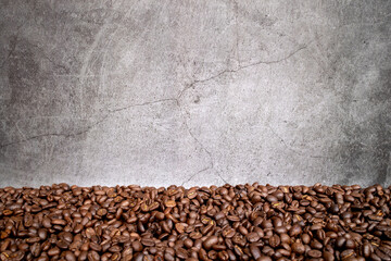 coffee bean on old cement with soft-focus and over light in the background. space for text