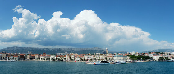 Fototapeta premium Split City Harbor from upper deck of large sea ferry boat. Sea, passenger ship, city skyline with mountains.