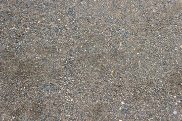 Fototapeta na wymiar Coarse sand with small stones.