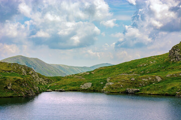 summer landscape with lake on high altitude. beautiful scenery of fagaras mountain ridge in summer....