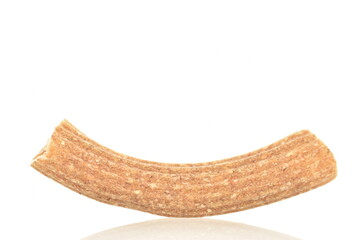 Dark brown, uncooked, organic rye pasta, close-up isolated on white.