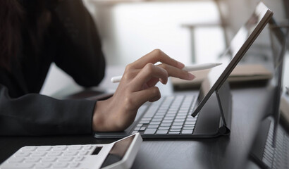 businesswoman use a digital tablet to check financial data.