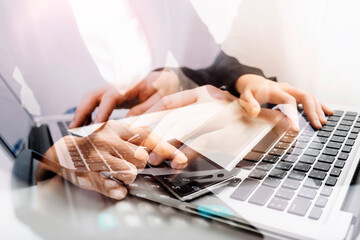 Businesswomen hands working with finances about cost and calculator and laptop with tablet, smartphone at office in morning light