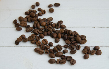 Coffee beans on a wooden white background
