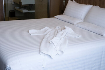 Fototapeta na wymiar Clean white bed in hotel. White comfortable pillow on bed in bedroom. Bed sheets and pillows. Large bedroom, hotel room with white sheets, large pillows cushions.