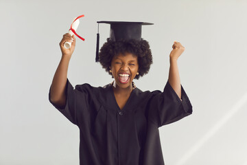 Excited young graduated african american woman student holding paper degree over isolated...
