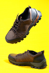 Men's shoes. Stylish sneakers on a yellow background. Isolated, close-up, levitation. High quality...