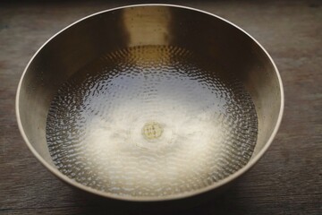 Singinn bowl filled with water for sound healing therapy 