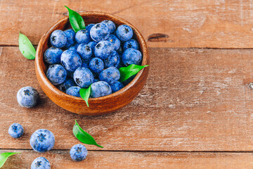  Blueberries in a bowl on a wooden background top view free space for text