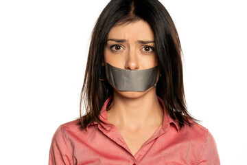 Woman with tape over mouth, isolated on white.