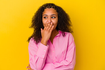 Fototapeta na wymiar Young african american woman isolated on yellow background yawning showing a tired gesture covering mouth with hand.