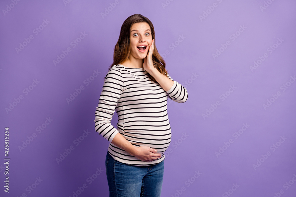 Sticker Photo portrait of pregnant amazed woman isolated on vivid violet colored background