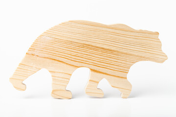 A figurine of a bear carved from solid pine by a hand jigsaw. On a white background