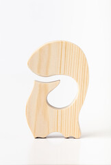 A figurine of a fox, carved from solid pine by a hand jigsaw. On a white background