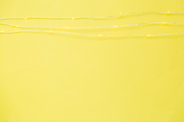 The garland is on. Glowing electric garland on a yellow background
