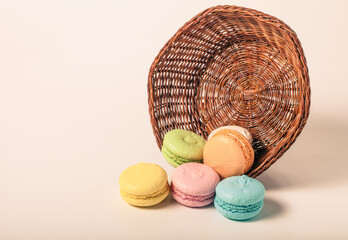 Colorful cake macaroons on a light background. Toned