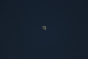 Brightly shining moon in a cloudless night sky