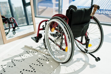 Empty wheelchair at home. Wheel chair indoor in mirror.