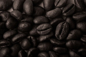 Roasted coffee beans like a background for wallpaper or decor. Toned