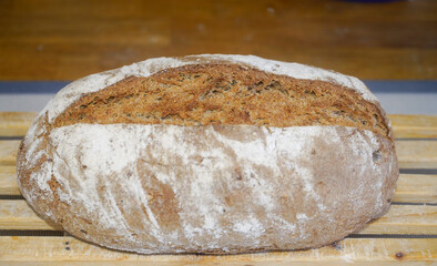 Homemade bread taken out of the oven and left to rest. Indoor photography. Product photography.